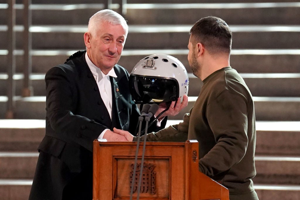 Speaker of the House of Commons, Sir Lindsay Hoyle, holds the helmet of one of the most successful Ukrainian pilots, inscribed with the words "We have freedom, give us wings to protect it", as it is presented to him by Ukrainian President Volodymyr Zelensky as he addressed parliamentarians in Westminster Hall on February 8, 2023 in London, England. (Credit Stefan Rousseau-by WPA Pool/Getty Images)